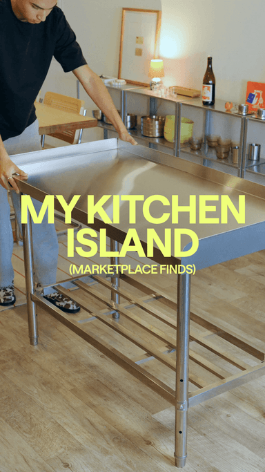Stainless steel kitchen island with pans stored beneath it